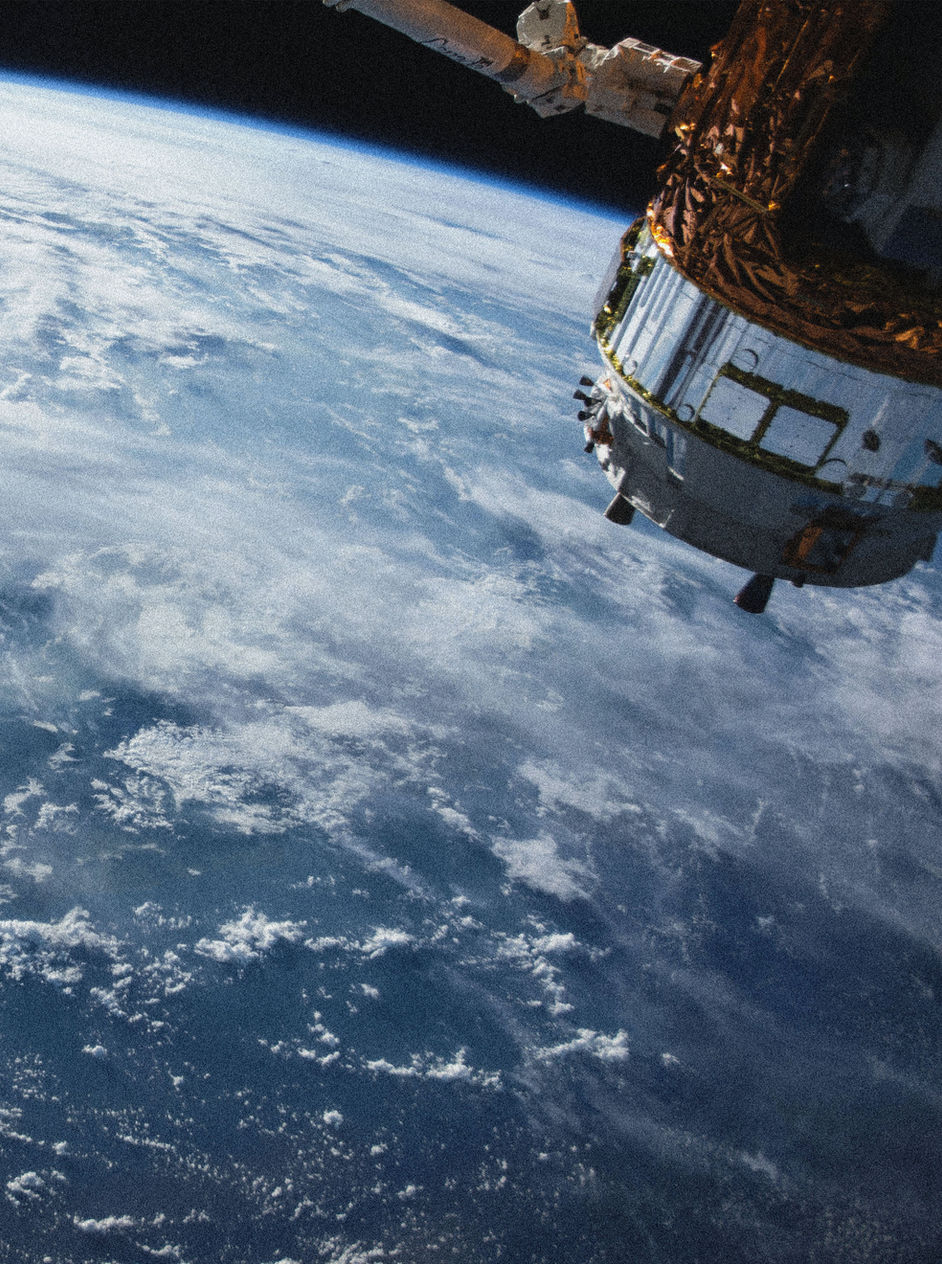 Earth seen from orbit with the horizon curving into darkness